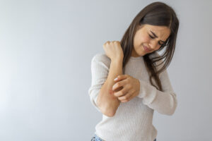 Women scratching dry skin with hand,