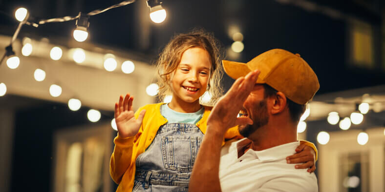 Man and young girl high five